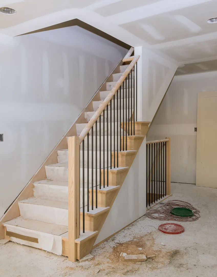 Home Wow Pro interior remodeling project in Los Angeles featuring staircase construction, drywall finishing, and custom wood railing installation
