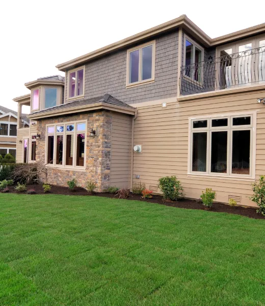 Home exterior remodeling by Home Wow Pro featuring updated siding, stone accents, large windows, and professional residential construction in Los Angeles