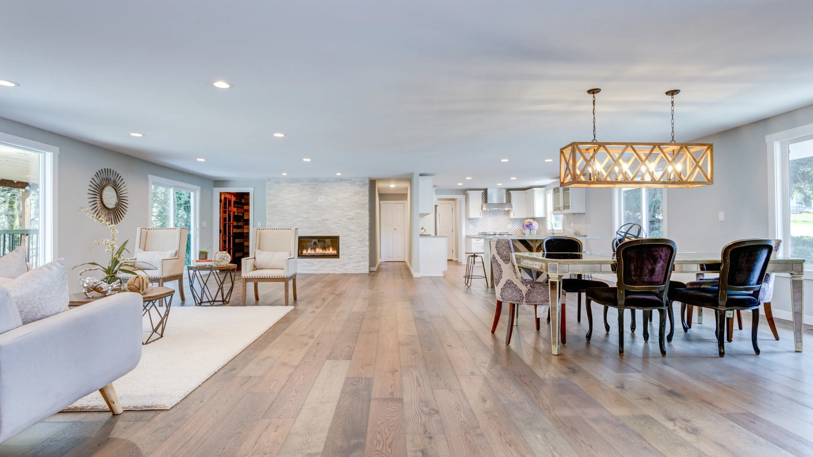 Before flooring installation project in Los Angeles showing an outdated open living and dining area with older wood flooring, traditional furniture, aging finishes, and worn interior surfaces