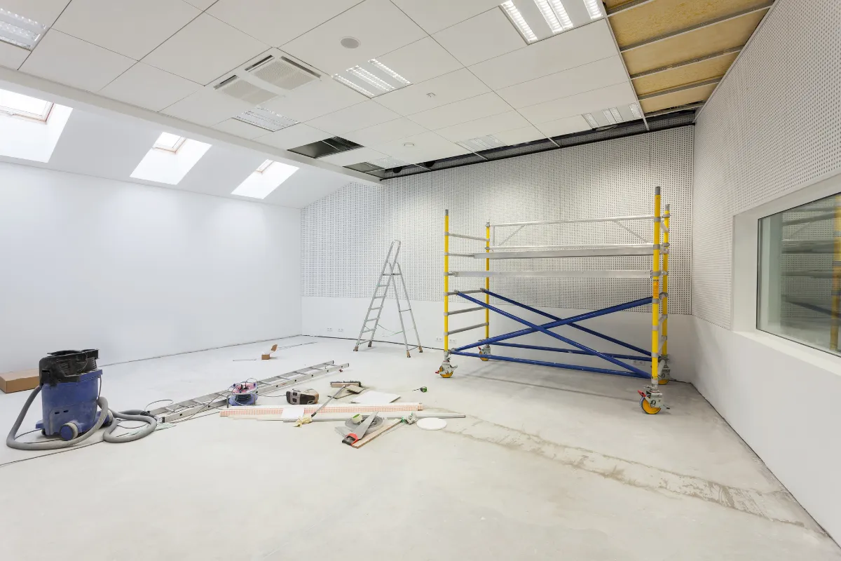Commercial remodeling in Los Angeles with ceiling repairs, scaffolding, ladders, and interior renovation work in progress