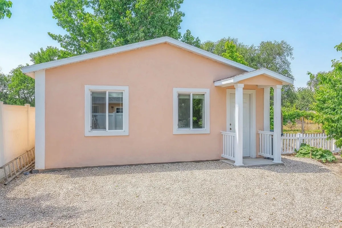 Garage conversion ADU in Los Angeles showing a small detached living unit with windows, entry porch, and private outdoor area