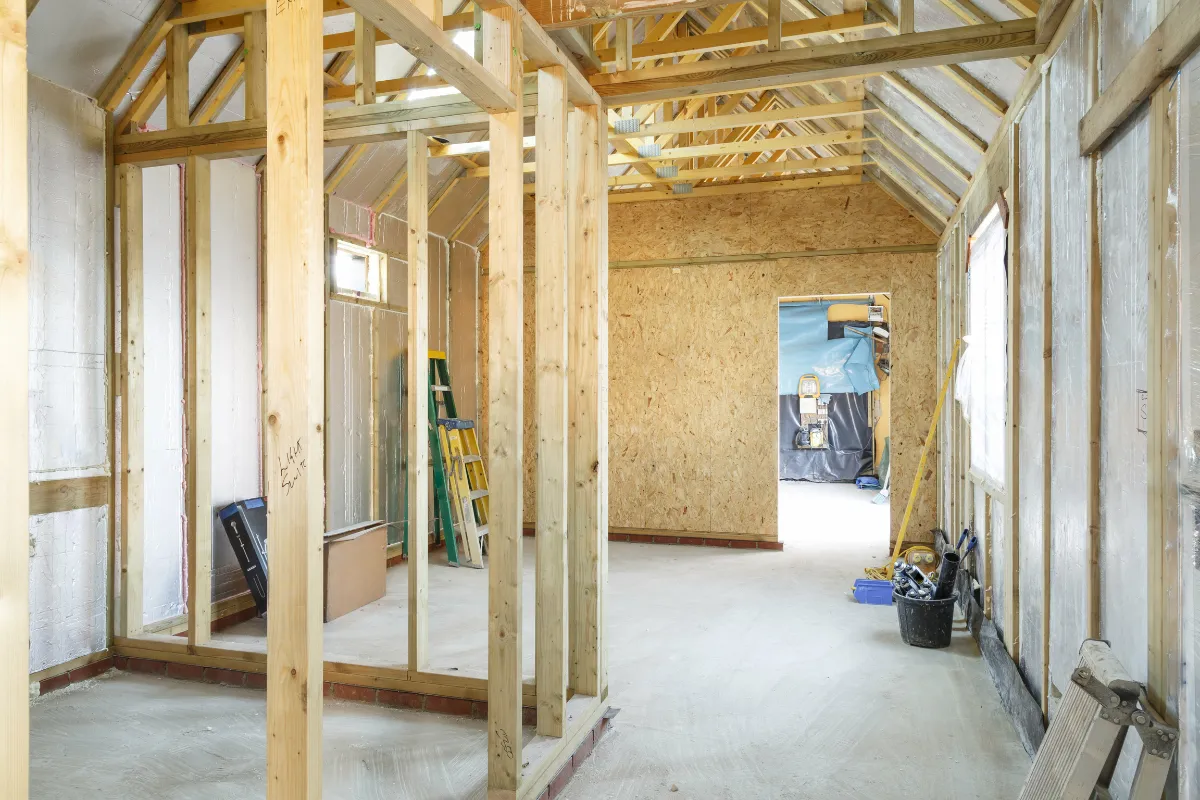 Room addition construction in Los Angeles with interior wood framing, insulation, open walls, and active build-out work