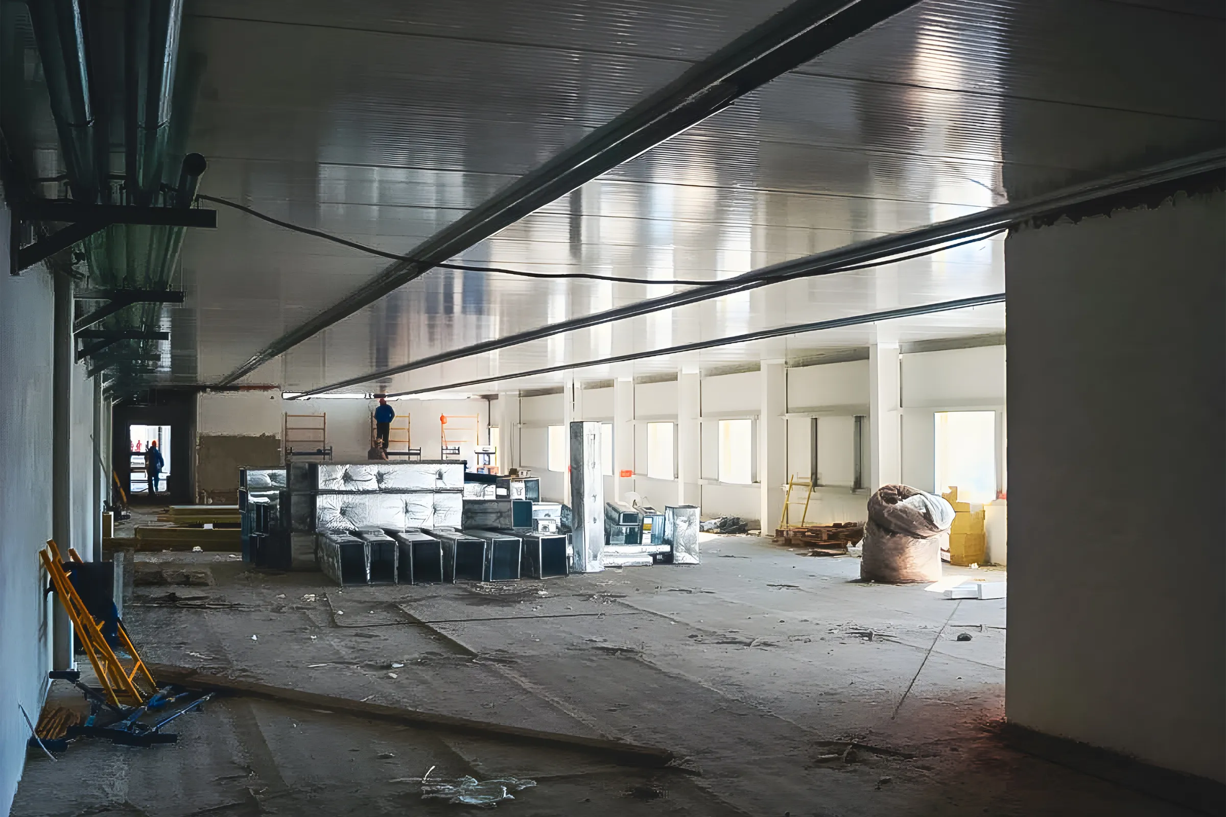 Commercial remodeling in Los Angeles showing a large interior build-out with ceiling work, construction materials, open floor space, and renovation preparation
