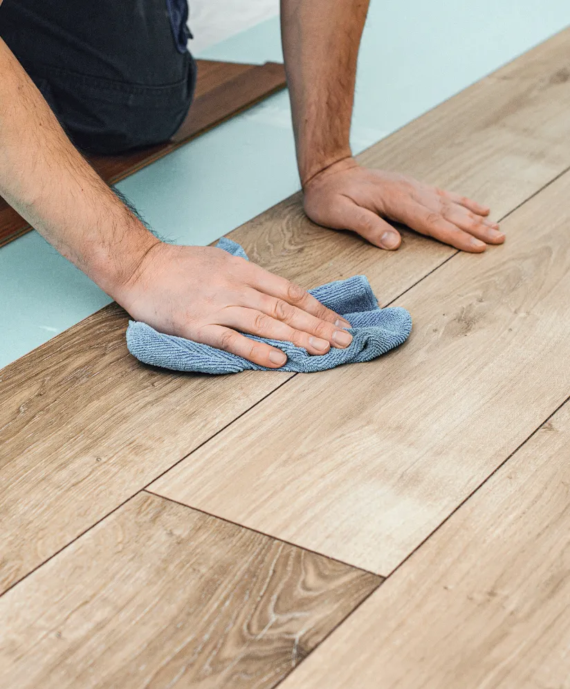 Los Angeles flooring installation project showing finished wood-look plank flooring being cleaned and inspected after installation
